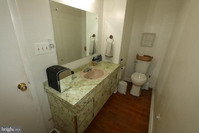 bathroom with vanity, hardwood / wood-style floors, and toilet