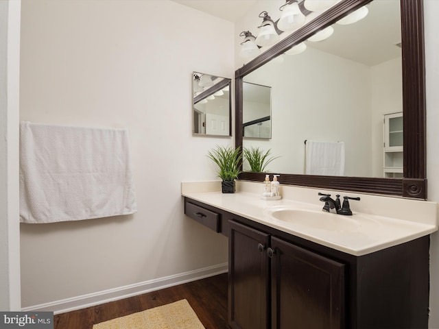 bathroom with hardwood / wood-style floors and vanity