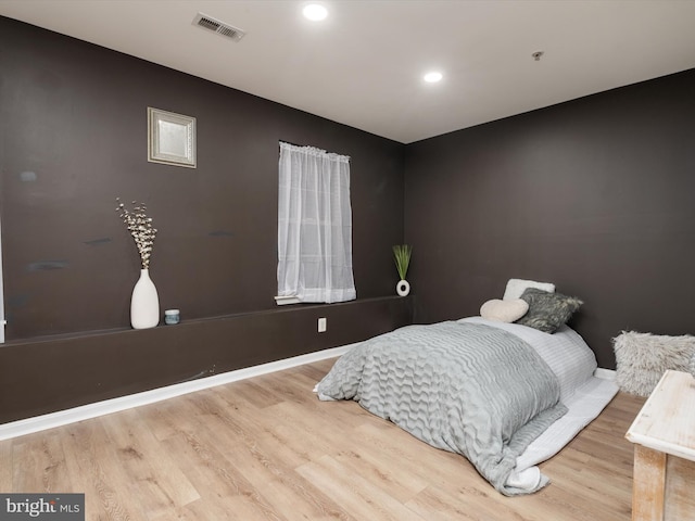 bedroom with hardwood / wood-style floors