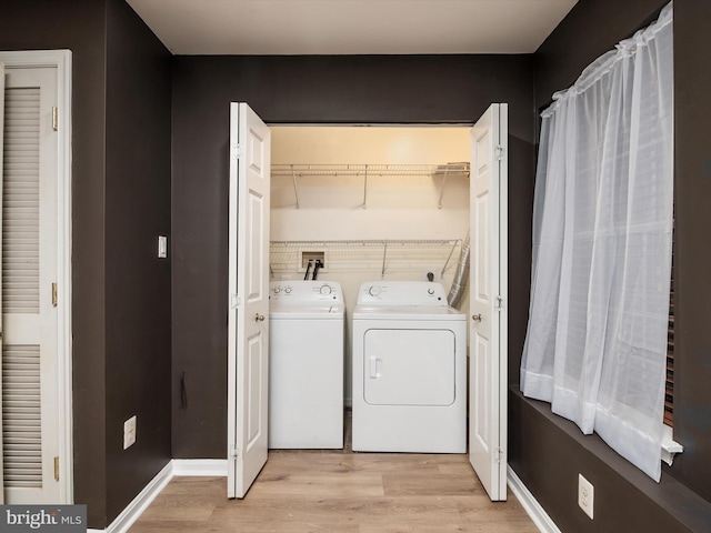 washroom featuring washer and dryer and light hardwood / wood-style flooring