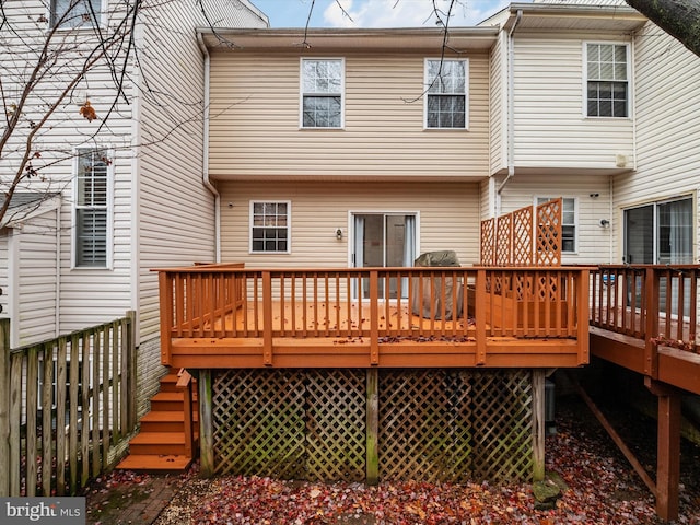 back of property featuring a deck