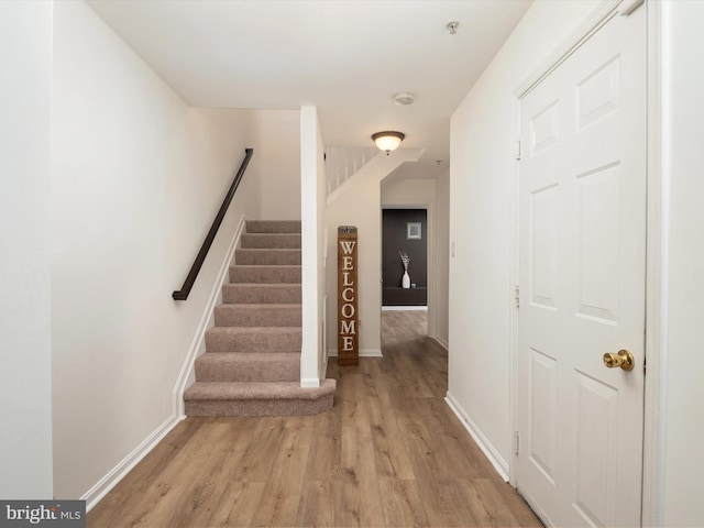 stairs with hardwood / wood-style flooring