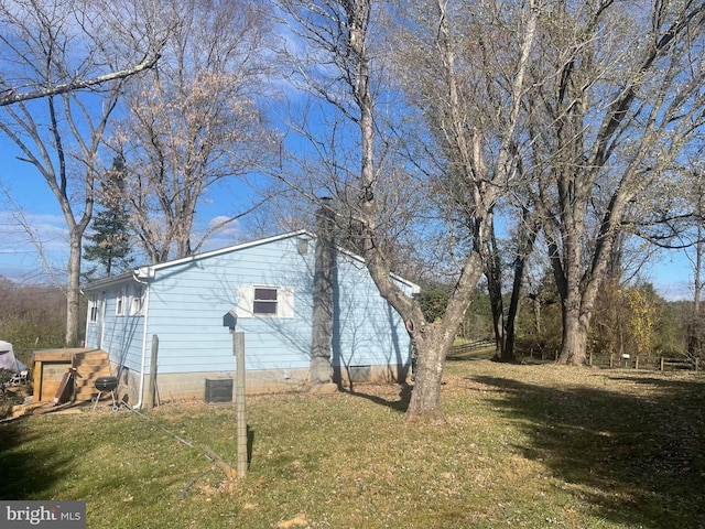 view of side of home featuring a yard