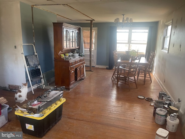 dining space with a notable chandelier and wood-type flooring