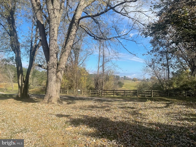 view of yard with a rural view