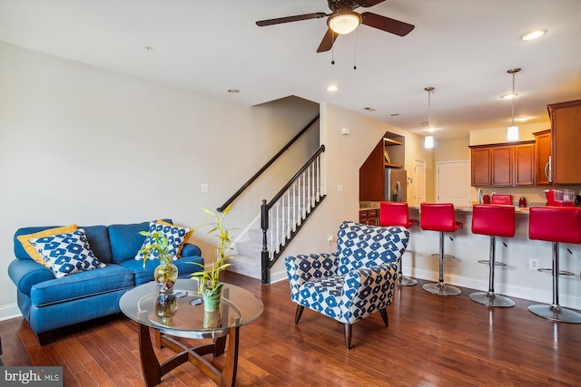 living room with ceiling fan and dark wood-type flooring