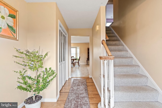 stairway with hardwood / wood-style flooring