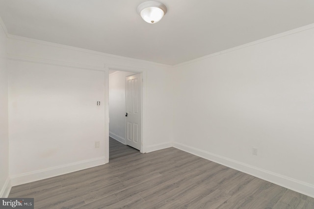 unfurnished room featuring dark hardwood / wood-style flooring and ornamental molding