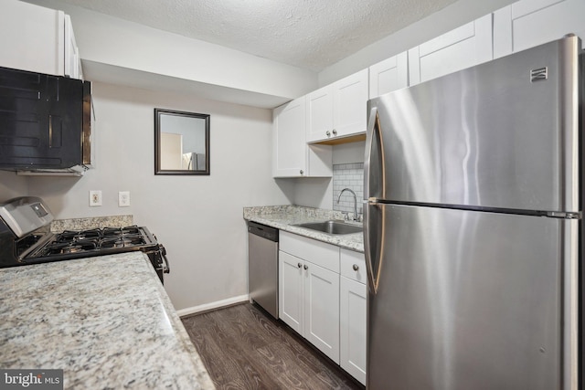 kitchen with white cabinets, stainless steel appliances, dark wood-type flooring, and sink