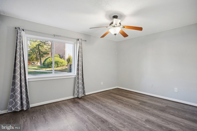 unfurnished room with ceiling fan and dark hardwood / wood-style flooring