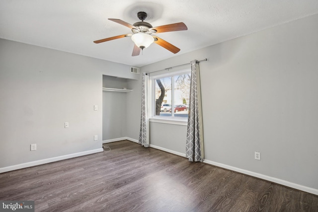 unfurnished bedroom featuring dark hardwood / wood-style flooring, a closet, and ceiling fan