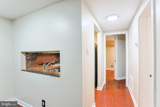 corridor featuring hardwood / wood-style floors and sink