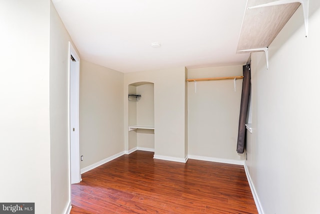 unfurnished bedroom featuring dark hardwood / wood-style floors and a closet