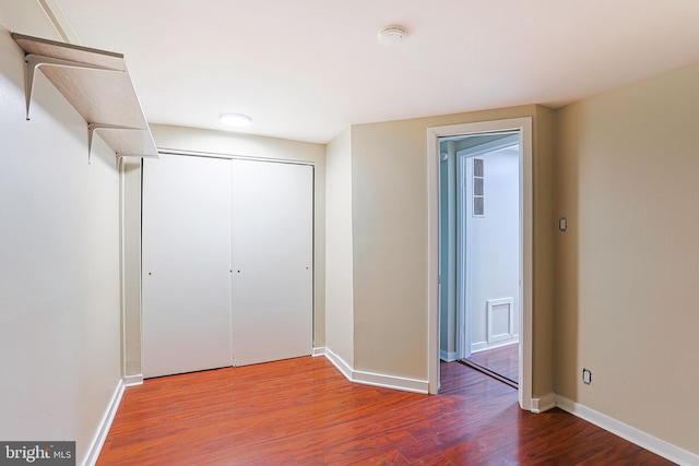 unfurnished bedroom with hardwood / wood-style floors and a closet