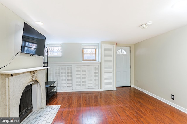 unfurnished living room with dark hardwood / wood-style flooring