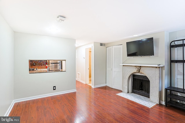 unfurnished living room featuring wood-type flooring