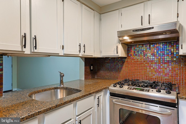 kitchen featuring white cabinetry, dark stone counters, and stainless steel gas range