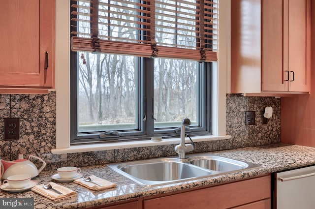 kitchen with sink, backsplash, plenty of natural light, and stone counters