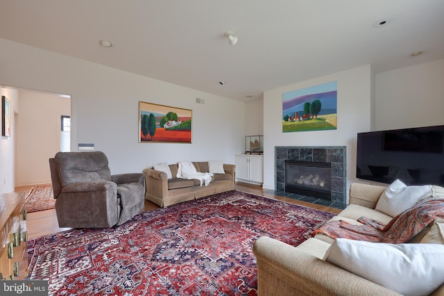 living room featuring hardwood / wood-style flooring and a fireplace