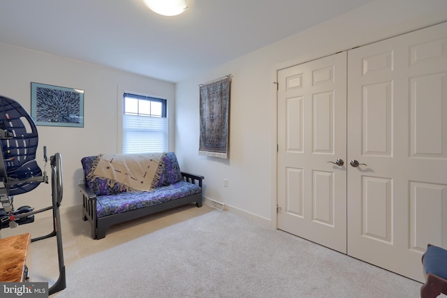 sitting room featuring light colored carpet