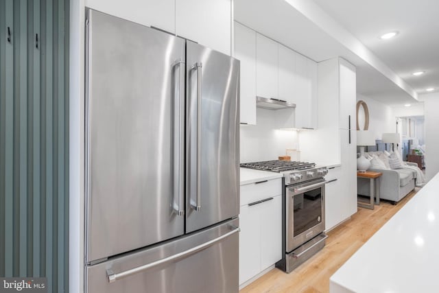 kitchen with white cabinetry, light hardwood / wood-style flooring, and high quality appliances