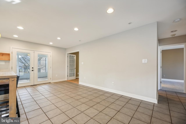 unfurnished room featuring french doors and light tile patterned floors