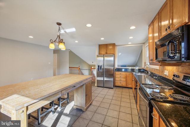 kitchen with decorative backsplash, stainless steel appliances, sink, pendant lighting, and light tile patterned flooring