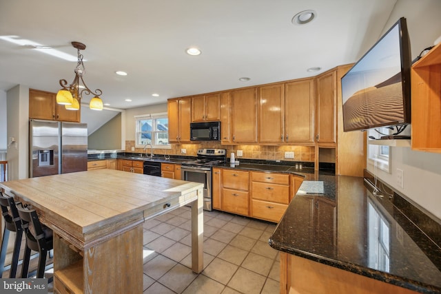 kitchen featuring a center island, black appliances, sink, decorative light fixtures, and a chandelier