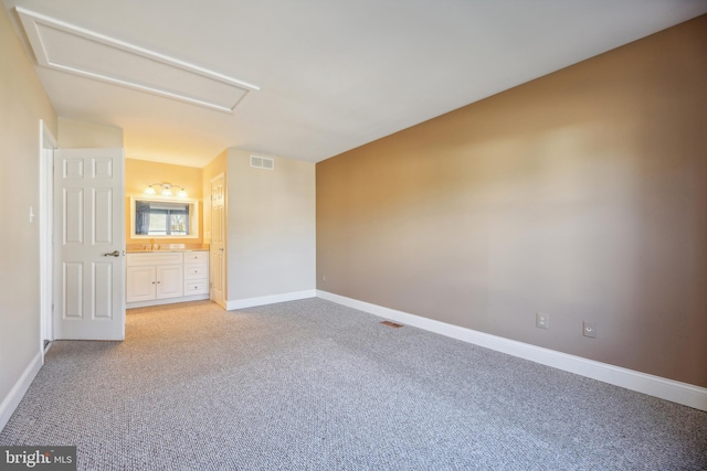 unfurnished bedroom featuring carpet floors, sink, and connected bathroom