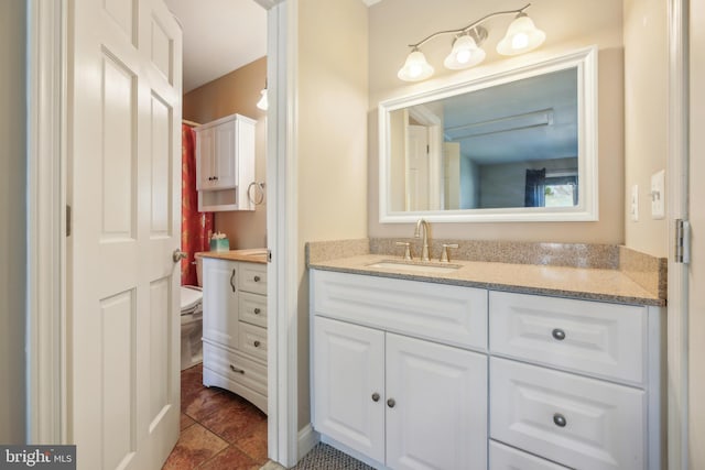 bathroom featuring tile patterned floors, vanity, and toilet