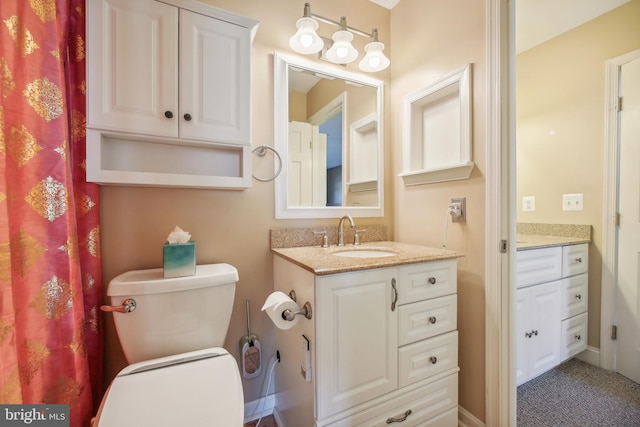 bathroom featuring vanity and toilet