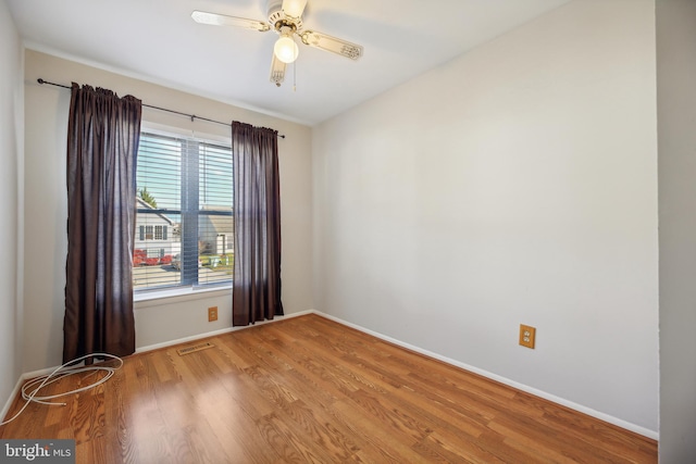 unfurnished room with ceiling fan and hardwood / wood-style floors