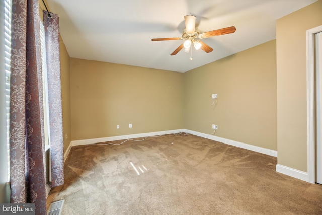 empty room with carpet flooring and ceiling fan