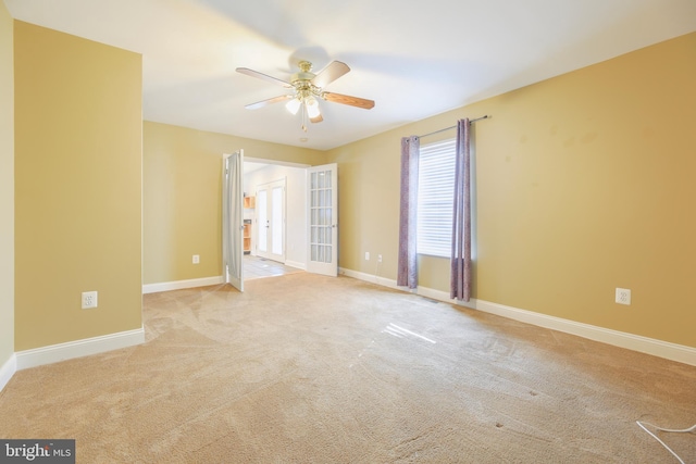 unfurnished room with light carpet and ceiling fan