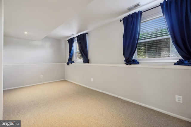 spare room featuring carpet floors and a wealth of natural light