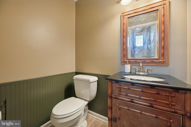 bathroom featuring tile patterned flooring, vanity, and toilet