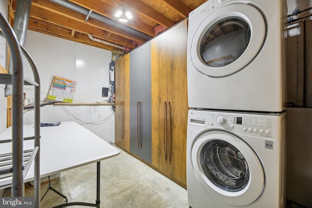 washroom with stacked washing maching and dryer