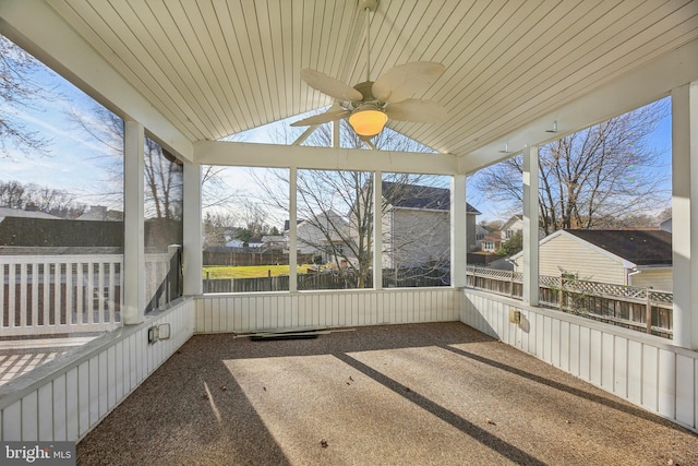 unfurnished sunroom with ceiling fan and wooden ceiling