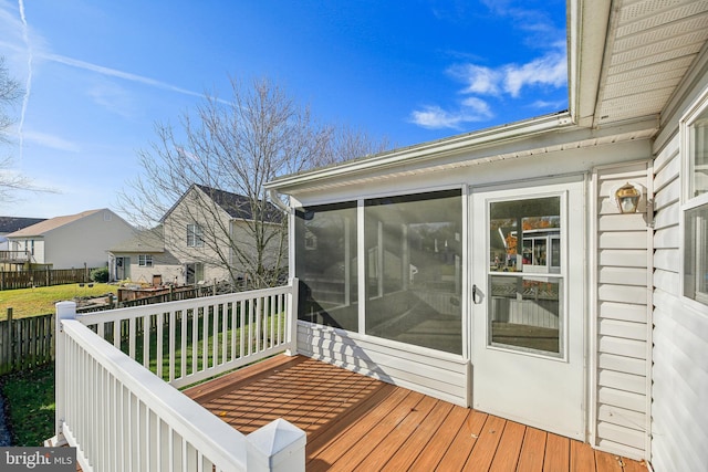 wooden deck with a sunroom