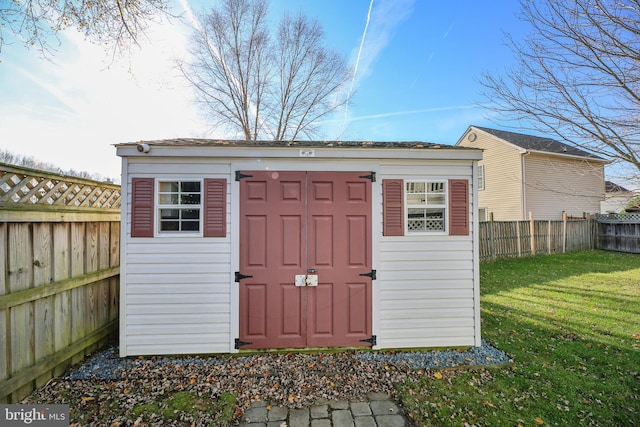 view of outbuilding with a yard