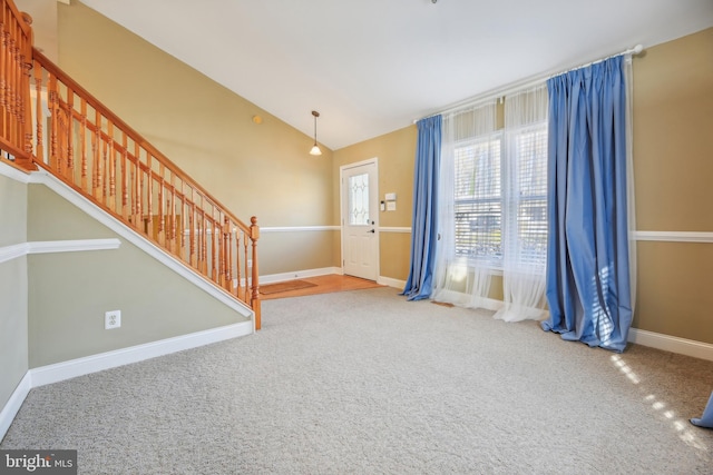 entryway with carpet flooring and vaulted ceiling