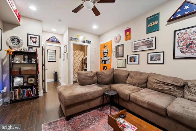 living room featuring ceiling fan and dark hardwood / wood-style floors