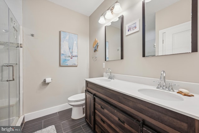 bathroom with vanity, an enclosed shower, and toilet