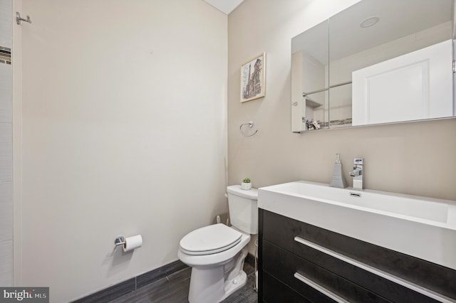 bathroom featuring vanity, toilet, and wood-type flooring