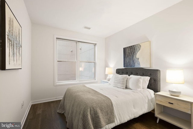 bedroom featuring dark hardwood / wood-style flooring