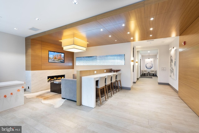 kitchen with a fireplace and light hardwood / wood-style floors