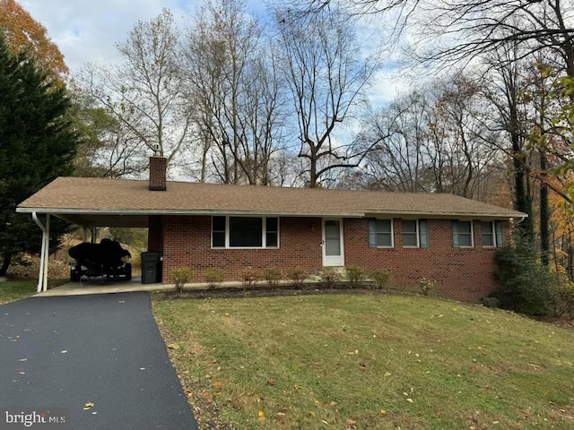 ranch-style home with a carport and a front lawn