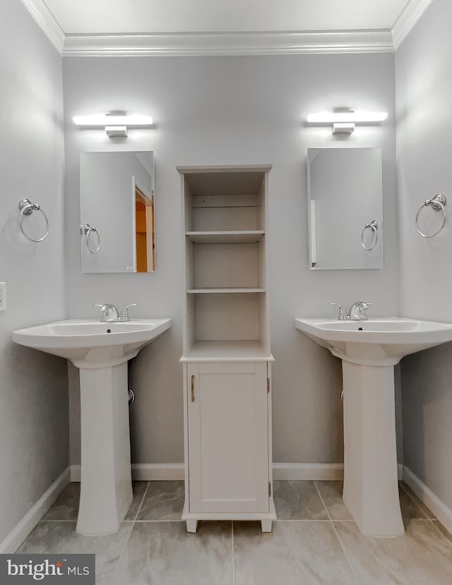 bathroom featuring ornamental molding and sink