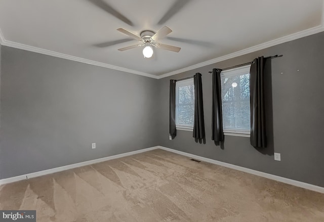 unfurnished room featuring light carpet, crown molding, and ceiling fan