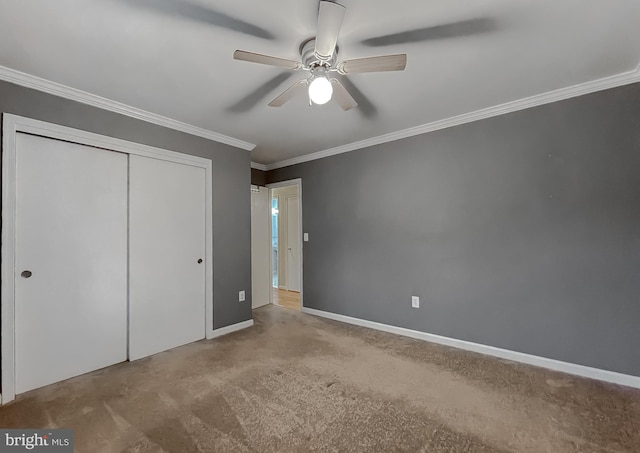 unfurnished bedroom featuring carpet flooring, a closet, ceiling fan, and ornamental molding